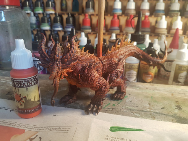 So the next step was to use Army Painter Lava Orange as a drybrush. I generally stayed away from the black feet areas this time, concentrating more on the scales, again drybrush against the direction of the scales.