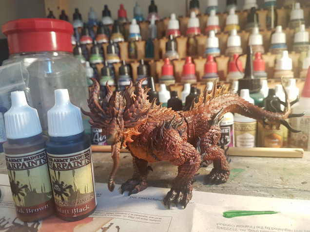 So the next step was to do a light yellow dry brush over the back fins and tail (no photo). I then mixed Army Painter Oak Brown (2 parts) and Matt Black (1 part) and picked out all the spines, horns, death and claws