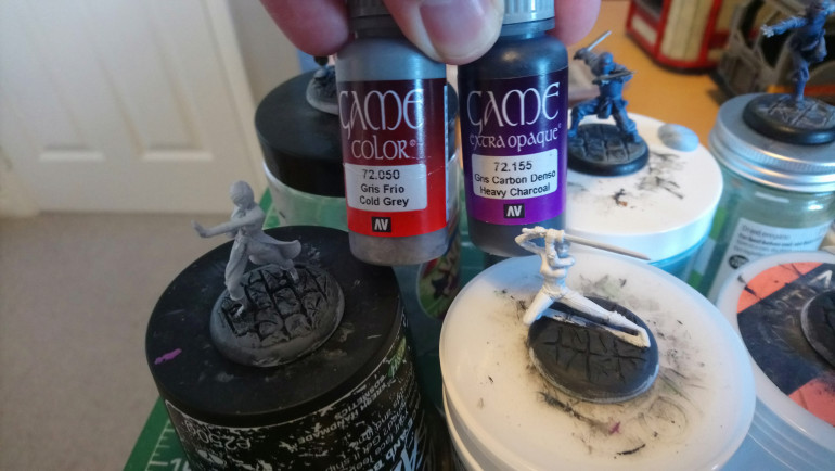 First I basecoat the bases charcoal grey, then apply a heavy dry brushing of cold grey to begin shading up. You can see the first two steps side by side here, with the basecoat on the right and a drybrushed base on the left.. 