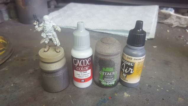 Stage 5 - Paint the armour sections with Vallejo Game Colour Ghost Grey. Paint the weapon(s) Vallejo Model Air Engine Grey (or any other dark grey). Finally wash the boots/lower leg with GW Gloss Agrax Earthshade