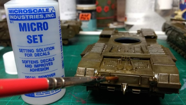 Decals go down best over a glossy, smooth surface, here the Army Painter dip wash gives a gloss surface. Alternatively, a dab of gloss varnish can be put down in the areas where a decal is to go. Leave the varnish to dry, then apply a drop of Micro-Set where the decal will go.