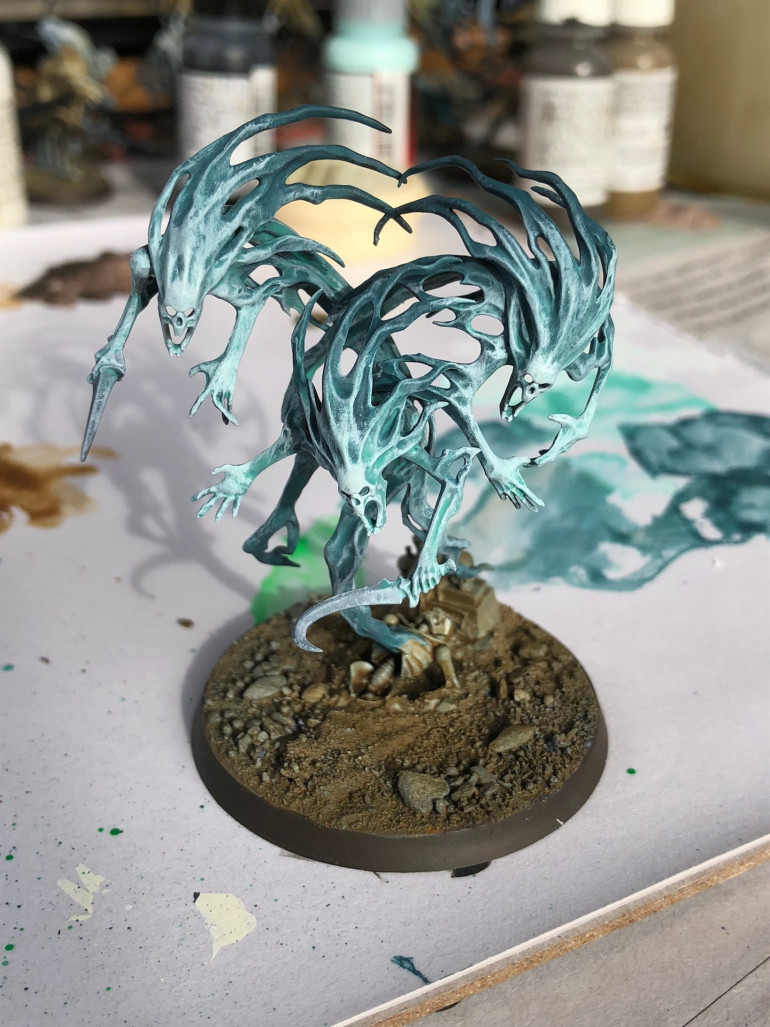 A verdigris (Vallejo game color) and white mix drybrushed to bring up the detail.
