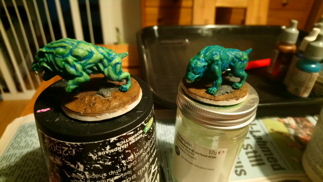 The hound on the right shows how I first 'shaded down' using first a mix of Vallejo Hawk Turquoise with AP Ultramarine Blue, then in the deepest recesses pure Ultramarine Blue.  At this point it looked like a mess!  On the left I have gone ahead and started to highlight mixing Vallejo Dead Flesh with the base coat AP Greenskin.