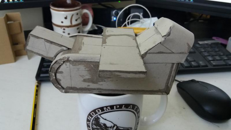 Cockpit shape changed and banding added to strengthen the box.