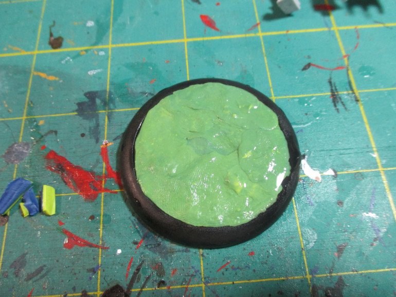 Prepare the green stuff and put it on the base so that it is level with the lip of the base.