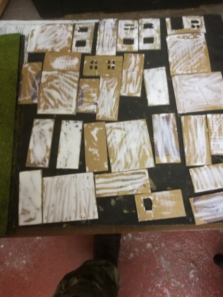 scratch building houses, cardboard supplied by the local book shop, sealing it with PVA.