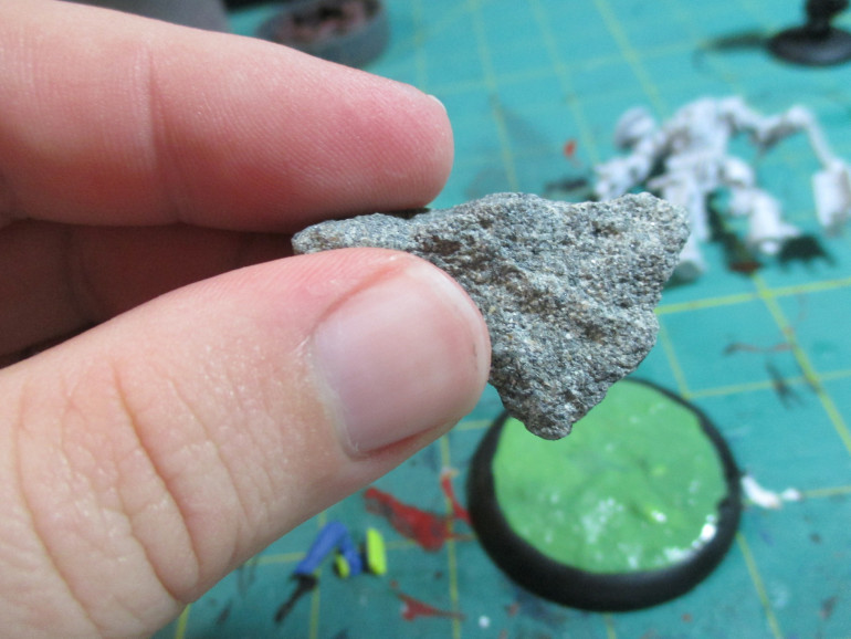 Take a rock, such as the one I have here and press it into the greenstuff to provide a rocky texture.