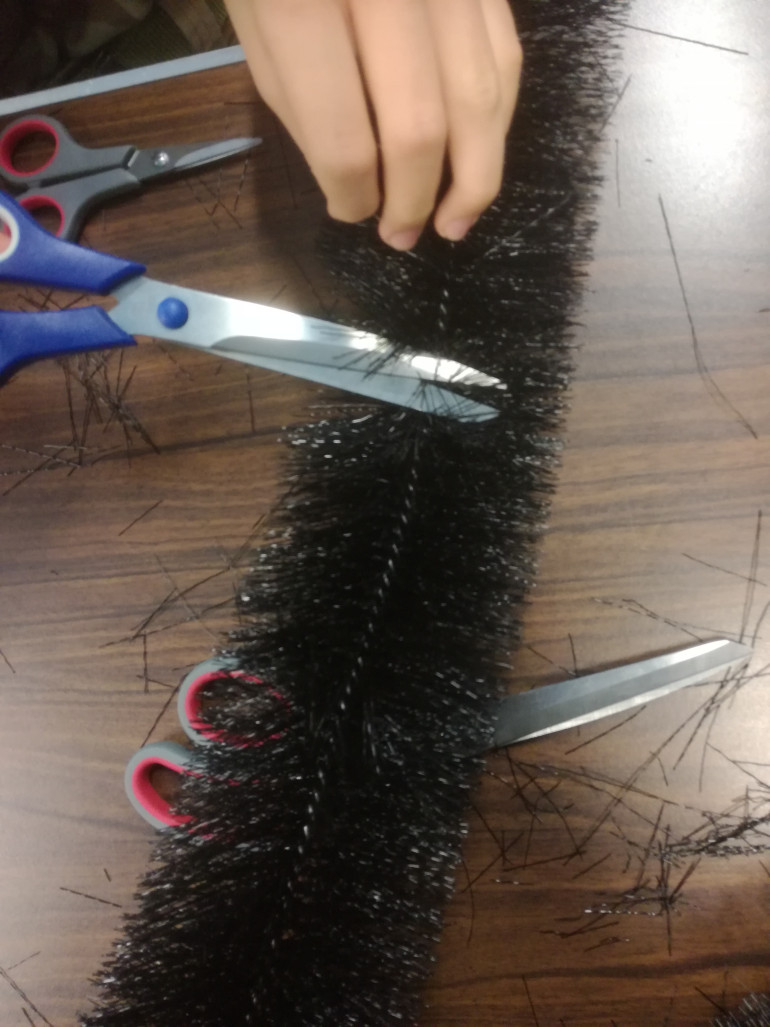 You'll need to trim your way towards the wire before cutting with pliers, we found if you use 2 pairs to untwist the area your snipping its easier to cut