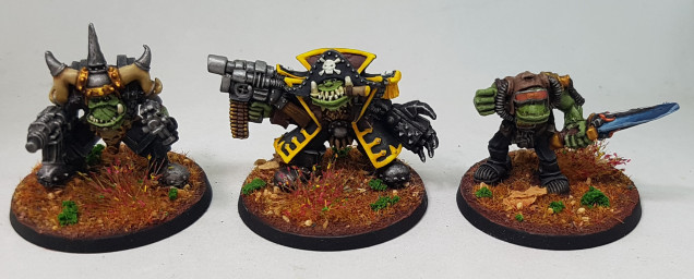 A Warboss, a Flash Gitz Freebooter with Power Claw Warboss, and another Warboss with a Power Sword, made from an old character called Bolko