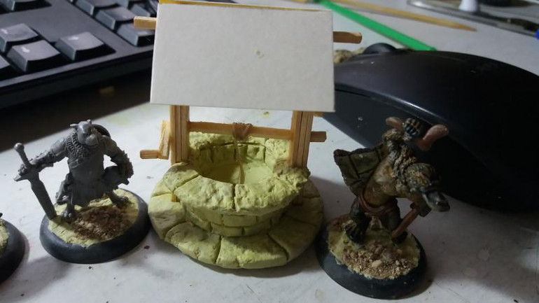 Well walls done, again with milliput, more of the wooden structure done and the roof blank is in place, minis for scale HF figure on the left and Oathsworns Platypus on the right.