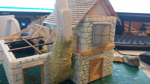 And onto the chimney, instead of the daub effect for other chimneies in the set, Ive gone for a rickerty stone effect, The form is off cuts of foam board and a milliput skin again textured with a real stone and carved with a sculpting tool.