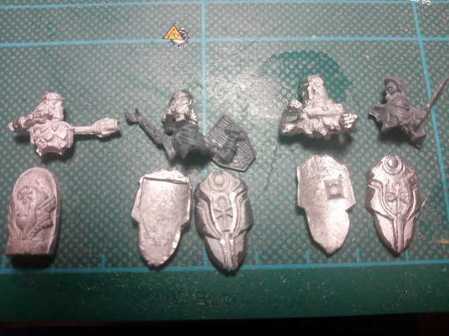 This image shows a mix of some of the themed, unthemed and detailing of the Empire of Dust models. The bottom left is a casket showing the level of details of the metal components, next to that are the two shield types those designed to go with the corresponding plastic or metal models. Again both show excellent details and the design to fix the metal to plastic shields gives a great contact surface. The top row shows an archer, themed metal head with standard body and themed torso and body. The last two can be adapted through weapon choice to bear swords or spears for the two different unit types.