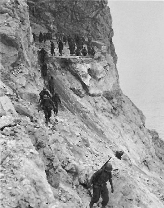 US 30th Infantry advancing along a destroyed coastal road