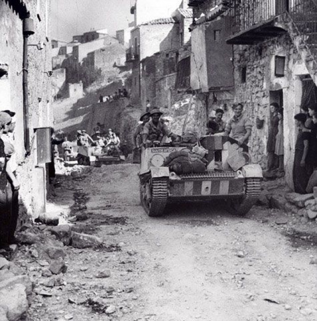 British Bren Carrier advancing through a town in Sicily