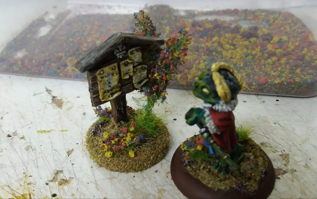 and flocked and added to the sign post. these are too large to add to a minis base but a cm long one would look fine.