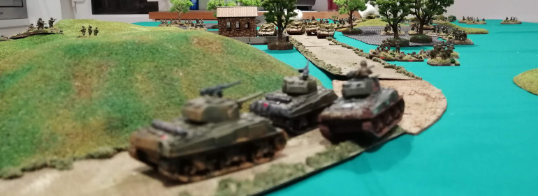 The Shermans 'Blitz' around the hill and try to line up the Panzers