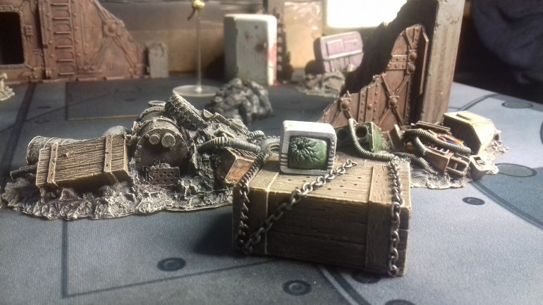 A crate with mysterious contents and a damaged TV, really pleased with how the screen came out ( these are two seperate pices of terrain, I have and am building a collection of individual items to personalise areas of terrain)