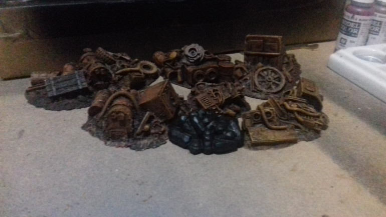 Some resin scenery ex pardulon now available from Crooked Dice. Ihttp://www.crooked-dice.co.uk/wp/product/junk-piles/ have under coated them black and drybrushed them in rust shades