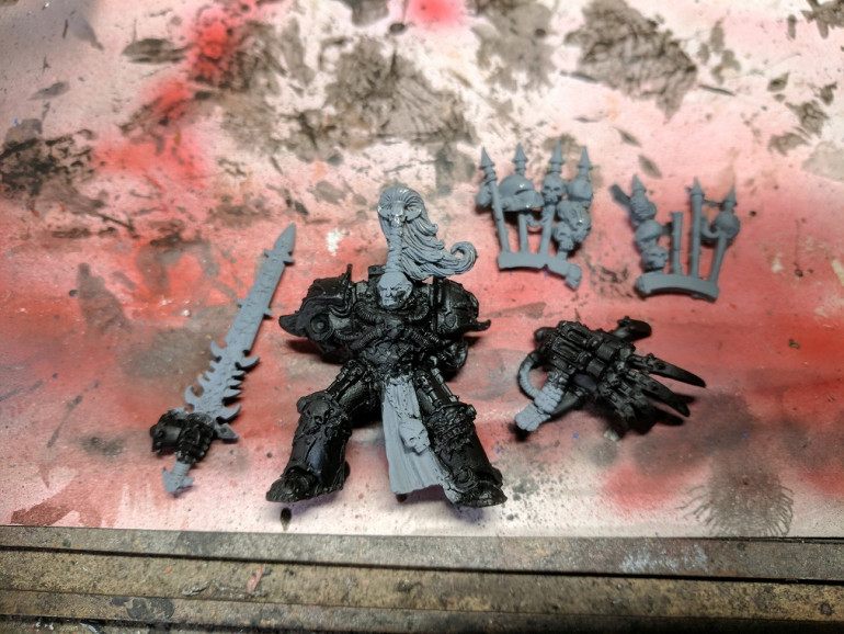 With the pose adjusted, it's time to start painting. Started off with a MIG grey primer then base coated all of the dark areas with 2 coats of thinned Abaddon black (quite fitting really) After stripping the model back i didn't want to loose detail by putting on thick layers of paint.