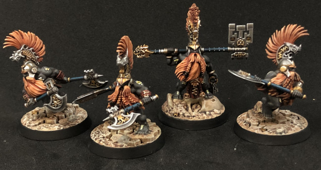 All four painted up like my first guy. Went for desert themed basing to contrast against the dark grey skin of the dwarves. Really like the results.