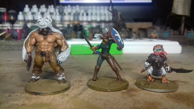 The three figures I am currently painting. Harrek the Beserk, Gunda the Guilty, and a duck.
