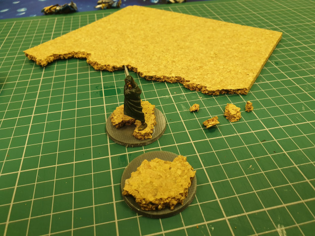 I want to give the heroes a little bit of body so I pulled out a sheet of cork and got to ripping and tearing!