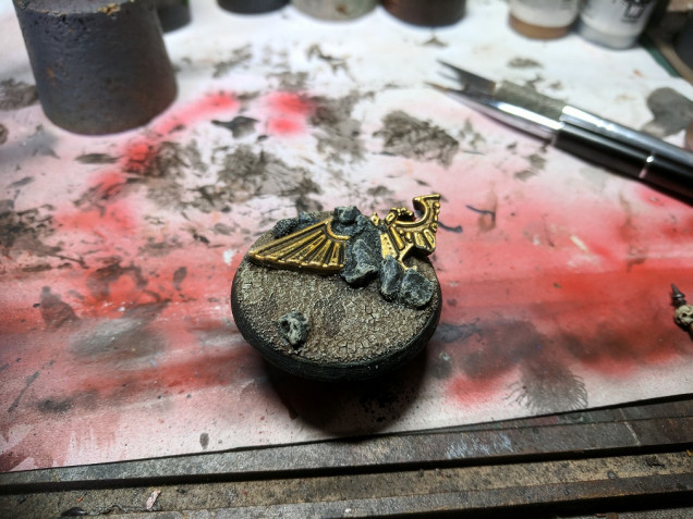 i applied some aggrellan earth technical pain to the base and gave it a few hours to dry, then went back and washed the whole base in agrax earthshade wash.