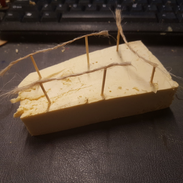 To Start a Washing Line I Stuck Two Toothpicks into a Piece of Foam. Then Trimmed them to Size and Super Glued a Single Strand of Jute String. Once the Glue was Dry then Fix Them in Place with More Glue.