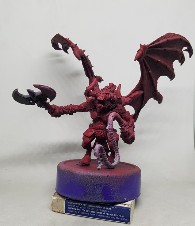 The Daemon was previously given a zenithal preshade and left overnight to dry.  I then dropped my airbrush prssure down to around 15 and thinned my paints down much futher and put a coat of VGS 72.111 Gory Red over the model.  This came out too pink for my tasts so I swapped it out for VGC 72.012 Scarlett Red.  The underside got minimal attention but the side and top got progressively more, still allowing the preshade to influence the colours