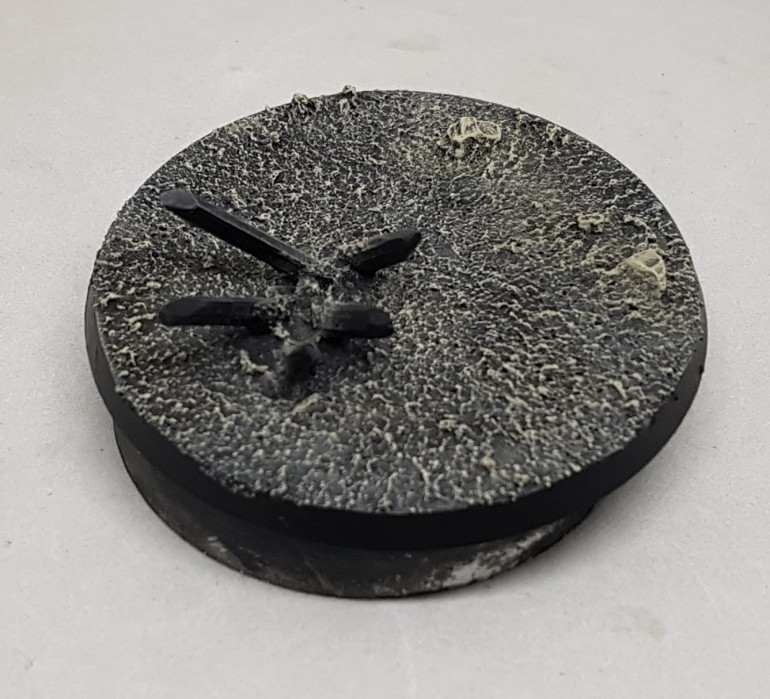 It was given a drybrush of GW Karak Stone and then GW Screaming Skull.  The edges were then reclaimed with black.