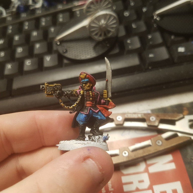 Any Attached Elements such as Techpriests, Fleet Officers or Commissars Retain their Old Equipment Although they will Often add a Trim to Represent the Unit they are Fighting With. Here we can See a Commissar Trimmed with the Pink of the Infantry. 