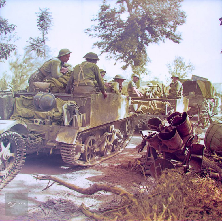 Relaxed British Infantry driving past a wrecked Nebelwefer