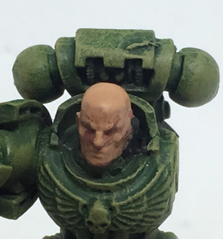 Highlight the face with Cadian Fleshtone, but leave the recesses well alone