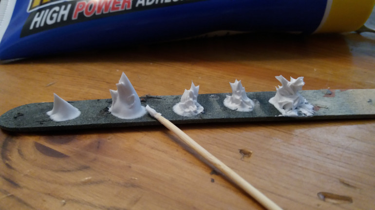 L-R a bit of a step by step, blob the adhesive onto your base, then gently work it with your stick of choice until you have something resembling flames. Dont worry you have plenty of time as it can be half an hour before its unworkable and it take a couple of hours to fully cure.