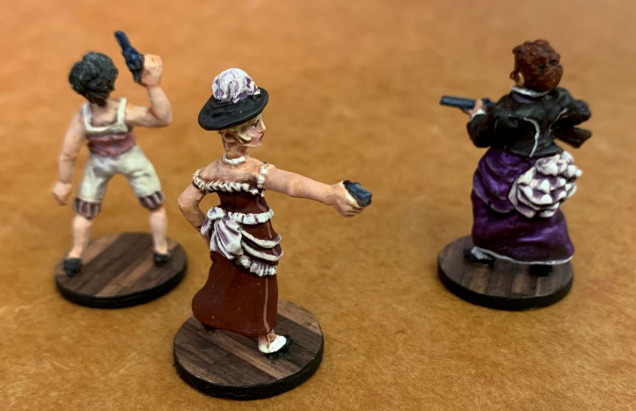 So I sawed the women off their metal bases and re-based them on new American nickels, covered in hardwood floor pattern I printed on cardstock.  This is because these figures will be on porches, balconies, etc ... on or in saloons rather than standing out in the open prairie.