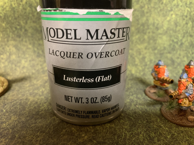 Testors Model Masters Flat Lacquer  This will help protect the figure and provide a universal flat sheen to all the figures. 