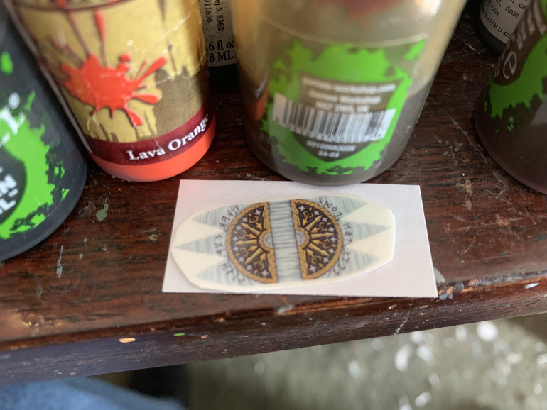 Cut out a piece of white paper larger than the transfer.