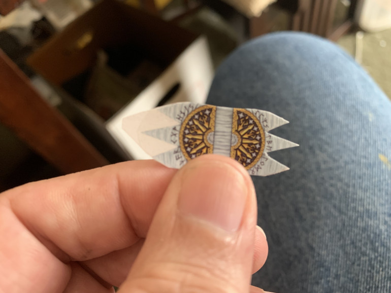 Once dry, trim the paper as close as possible to the transfer.