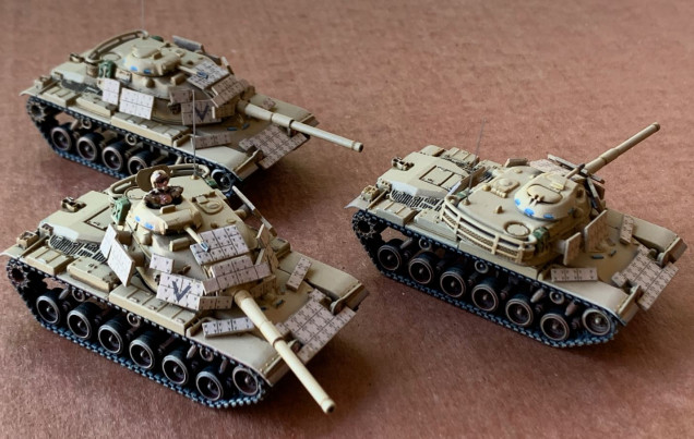 Here are the three tanks again, with the ERA panels re-mounted in much better positions.  I've also mounted antenna (bristles from a small plastic whisk broom - after drilling the radio antenna mounts).  This photo was taken in outdoor daylight in an attempt to give a better impression of what color these vehicles actually are (photographing khaki / sand with indoors light is pretty tough).