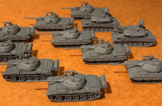 The kit comes with 9 T-54s.  Three I built as straight up T-54s.  Three I built as T-54s with side skirts on them (records show a mix of T-54s/55s, some with skirts, many without).  I also used some of the T-55AM2 kit pieces, other bits out of my 