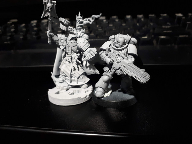 Interrogator is a bit bigger than normal primaris, but its because he is standing on some rubble. If we take out the rubble they should be same height.