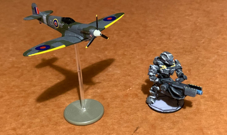 Built a new flying stand for this new diecast metal Spitfire (apparently in markings for a Free Polish RAF Squadron) I bought at Historicon.  Also, as cleaned up the last of my hobby table, I found where one last Halo gunner had fallen behind the table, where it had gone unpainted for almost a year.  As described on the Halo project thread, this guy was formerly clear plastic (apparently some kind of holographic or AI character), so I tried to prime him as best I could, paint him in urban camoflage, give him some markings, augment his support weapon, and give him a base.  There are over 100 of these guys on the Halo project thread, and I thought they were all complete.  But apparently this guy was AWOL, now returned to the ranks!  :D   Mega Bloks toy, not really a miniature (obviously), almost 2