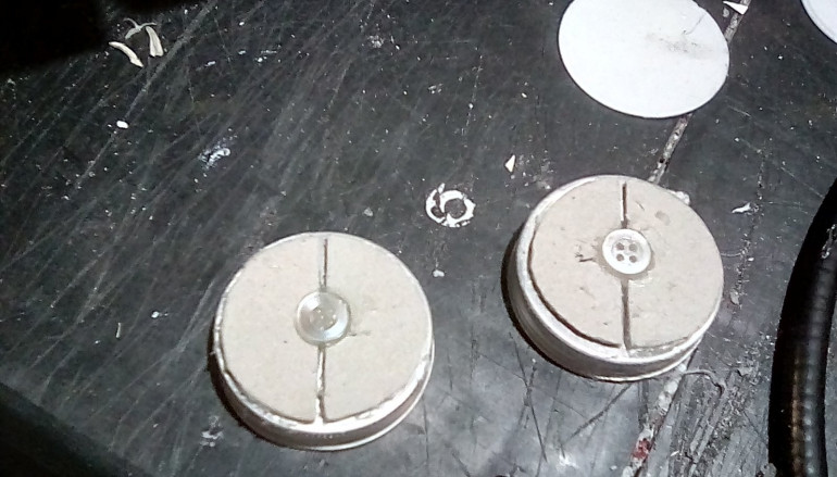 2 half circles of card are glued on, leaving a gap down the middle, to represent the airlocks inner doors. To just add a bit of detail, I glue on a.small button to represent the doors lock..