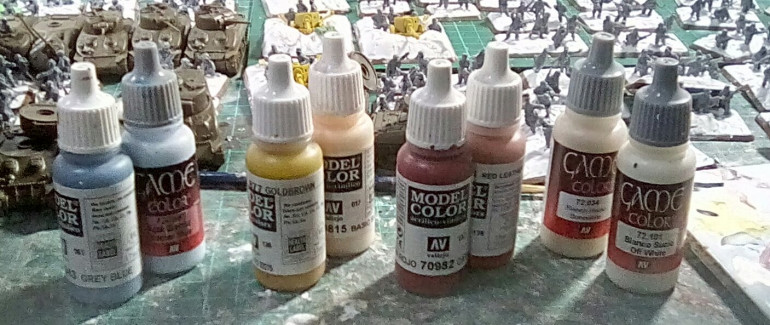 The paints I used to paint the coloured panels. 2 thin costs of the watered down darker base colour, then overpainted with the lighter shade letting the darker shade show at the edges. Then firebrand aged with the 2 off-white shades.