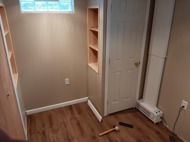 Flooring and trim down, some built in shelves to help maximize space. 