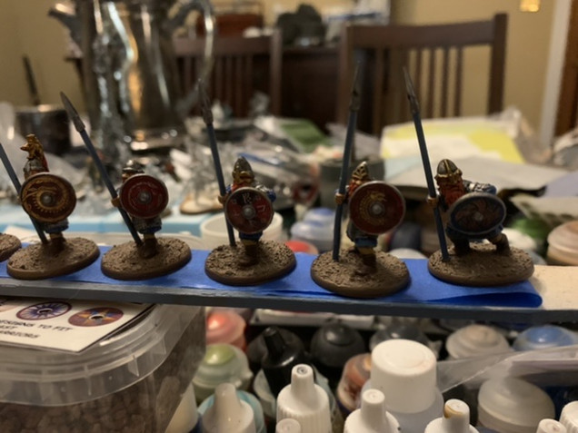 Once the shields were painted I applied the transfers are previously then glued the shields onto the minis. I then based the minis as previously adding the cork rocks and the tufts. 