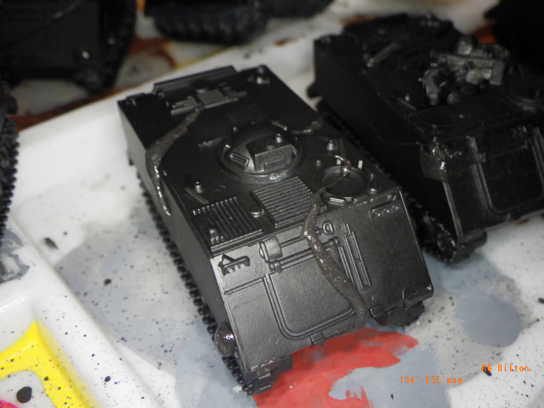 Apply little blobs of Panzer Putty to hide some black, in varying shapes for uniqueness