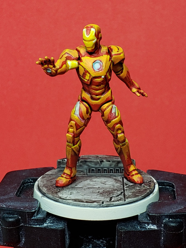 So this is step 2 on Iron Man, bringing in a mix of Fire Dragon Bright to the Flash Gitz Yellow to feather the bright yellow highlights into the red. As you can see, it still looks very, very terrible. Hopefully it'll look better and better as more layers get added in.