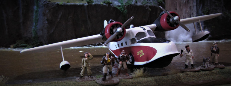 The minis are from Pulp Figures, Buzz Barker's Island Hoppers with an addition of the Jake Cutter figure from the Rugged Heroes pack.  The characters on the right are the ones from the TV series, Jake the pilot in his Flying Tigers jacket, Corkie the mechanic and Jack the dog with his eye patch.