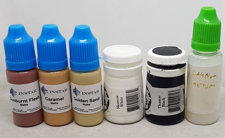 For anyone playing along at home, here are all the paints used so far. Any time I was applying a shade or highlight I mixed in a little Lahmium Medium in the hopes of enhancing its transparency